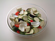 Image of a microwave-safe bowl with all the ingredients needed by the appetizer recipe
