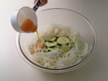 Photo of pouring Sunomono sauce over cucumber.