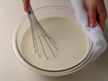 Image of stirring white sauce after adding salt and pepper.