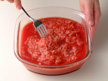 Image of stirring the cooked mixture of ground beef and tomato sauce.
