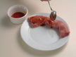 Image of spooning Grilled Pork Sauce over pork.
