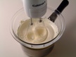 Image of mixing egg yokes,sugar, vanilla extract, and milk in a bowl.