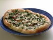 Image of Pizza with fresh tomato and basil: a speedy microwave pizza recipe provided with nutrition facts for a family dinner dish.