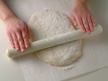 Image of rolling out the pizza dough.