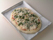 Image of the pizza topped ready for baking.