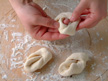 Image of inserting one end of a dough piece through the hole.