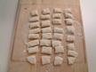Image of 32 pieces of dough on a board.